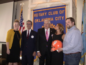 Gina, BBJ's wife, and family with KFOR Manager Wes Milbourn and Pres. Tim Strange accepts a helmet with the Bedlam BBJ Memorial Bedlam Logos